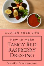 Pinterest mini image - Red raspberry salad dressing in a small bowl next to a fruit salad garnished with some fresh mint leaves