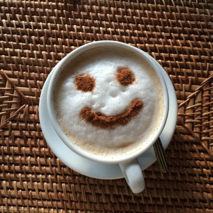 Coffee with foam with a cocoa smiley face