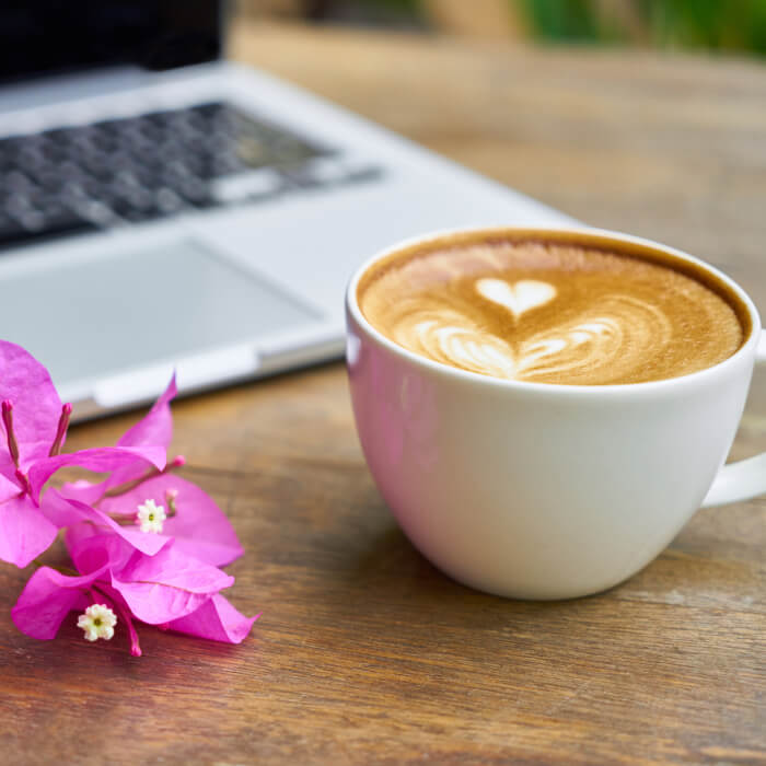 Cup of latte with a computer