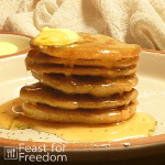 Grain free pancakes on a plate with butter and syrup