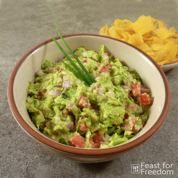 Fresh guacamole with chips on the side