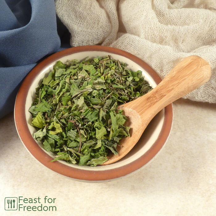 Italian seasoning in a small bowl with a spoon