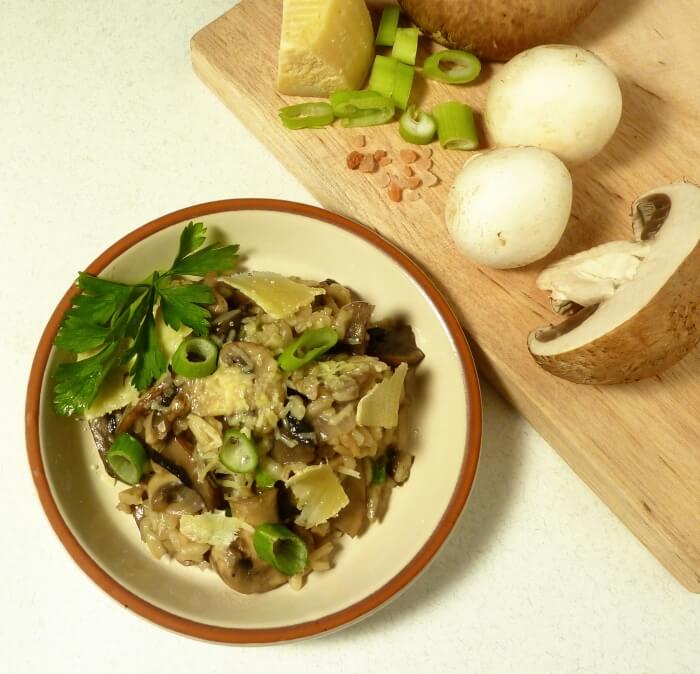Mushroom risotto on a plate with fresh grated parmesan cheese