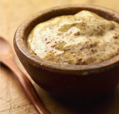 Whole grain dijon mustard in a wooden bowl